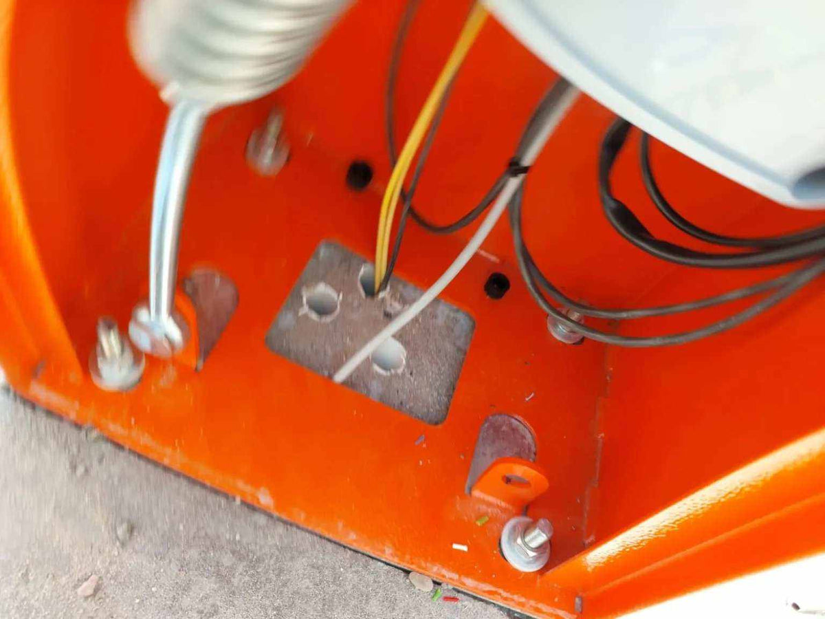 Comunello BORDER 400 Automatic Parking Barrier with an orange metal cabinet base, exposed wiring and mounting bolts