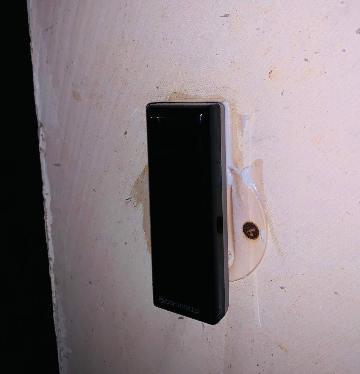 Comunello DART SLIM Gate Safety Photocells, slim black rectangular sensor mounted on a white bracket with a visible screw.