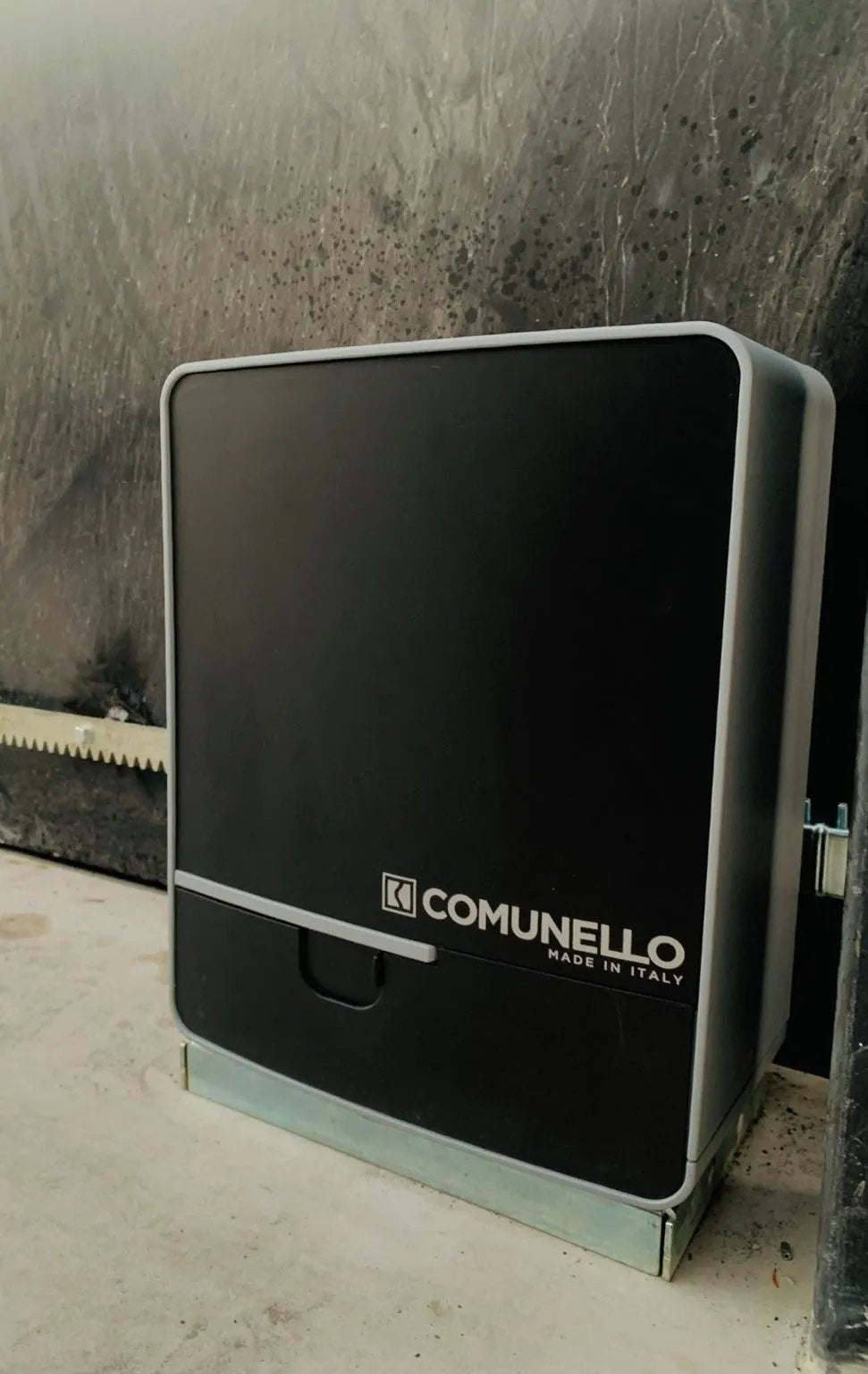 Comunello FORT 1500 Sliding Gate Motor with a black plastic cover, grey trim, front logo and toothed rack
