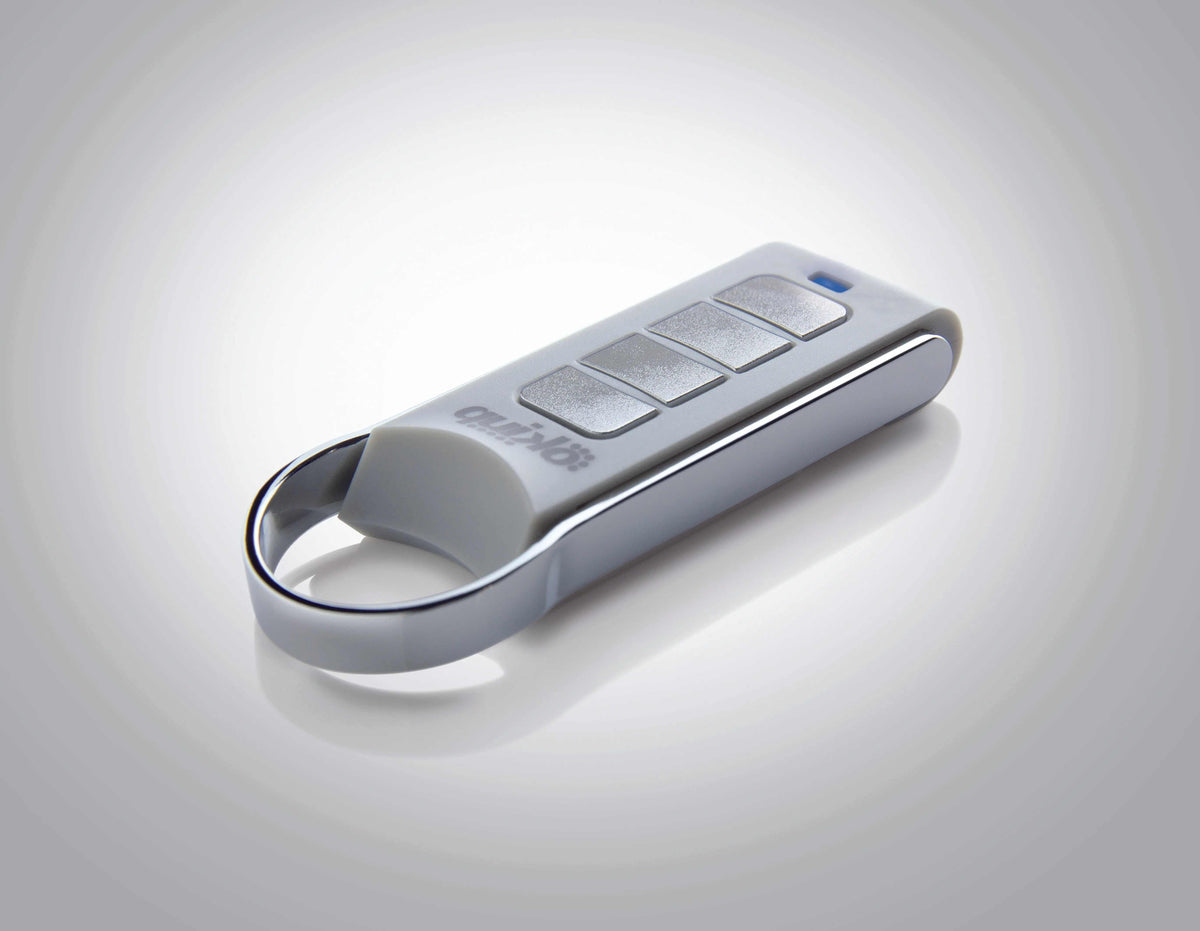 Quiko 4-Channel Gate Remote with a silver and white casing, four rectangular buttons and a keyring loop