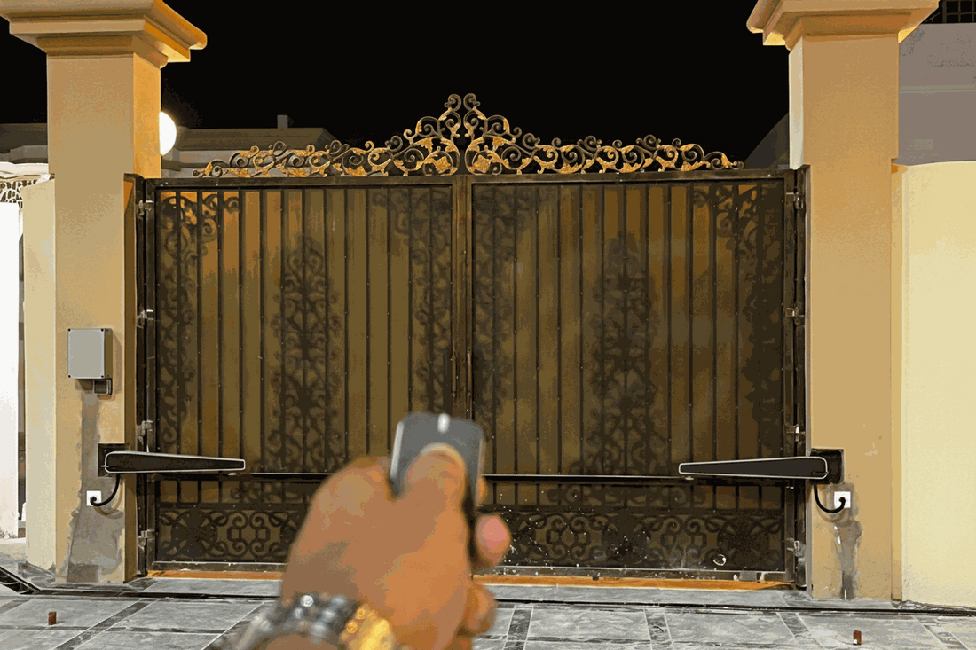 Ornate black metal driveway gate with gold detailing and matching pillars, opened by remote during Gate Maintenance in Qatar
