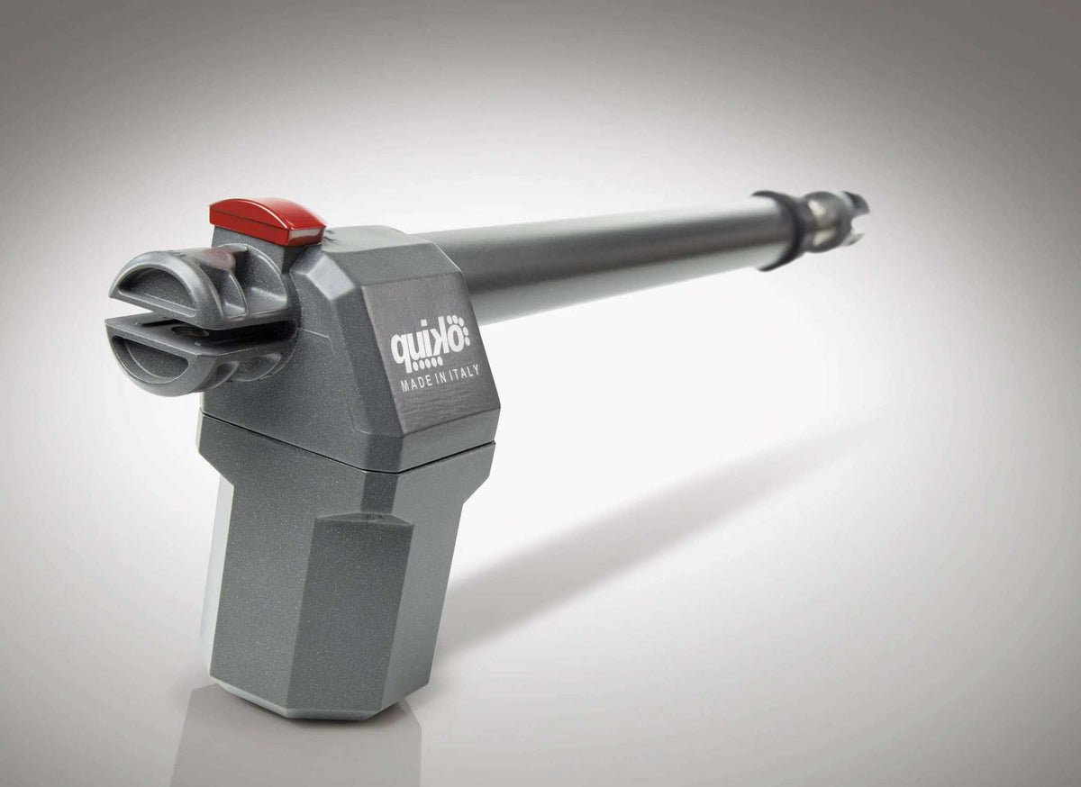 Quiko EON E-600 Swing Gate Operator with a gray metal housing, long silver actuator arm and red release lever.