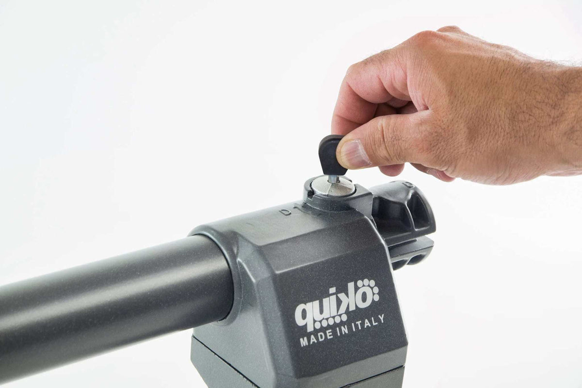 Quiko EON E-600 Swing Gate Operator in dark gray metal, with a long cylindrical arm and a visible manual release key.