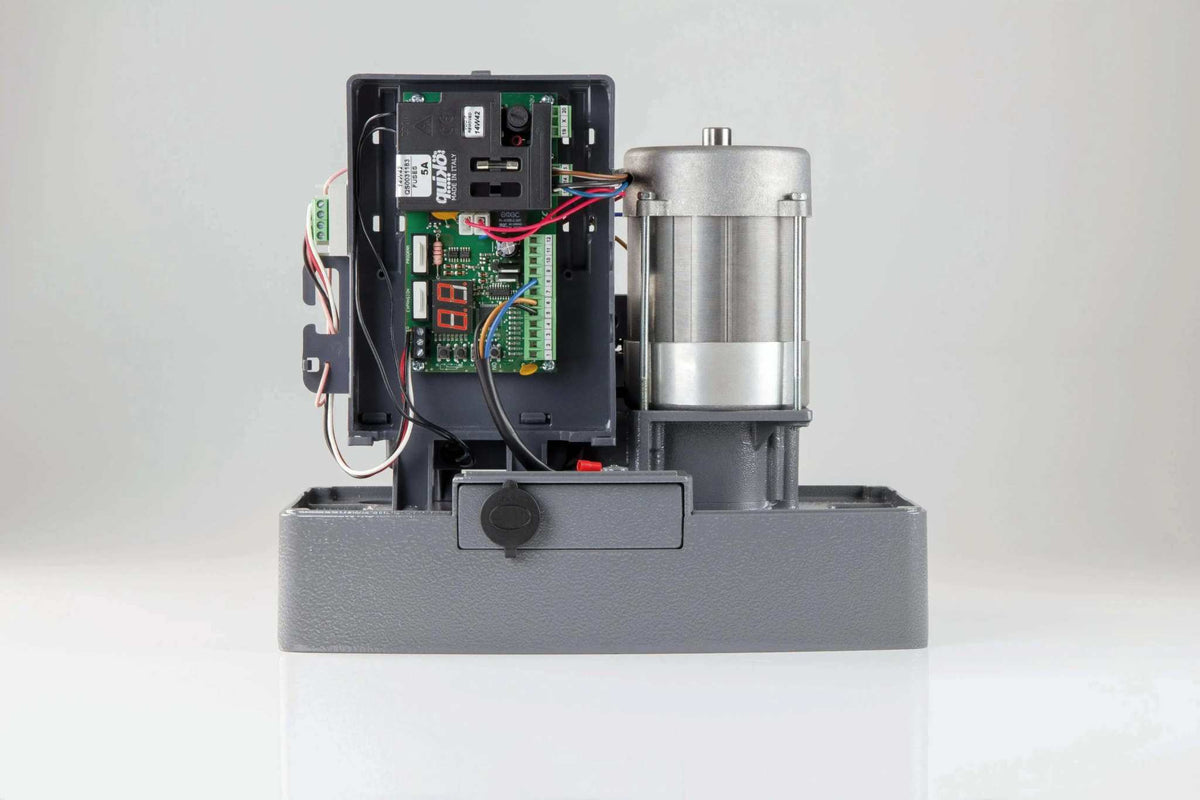 Quiko MOOVY Sliding Gate Operator with a grey metal base, exposed circuit board, wiring and silver cylindrical motor.