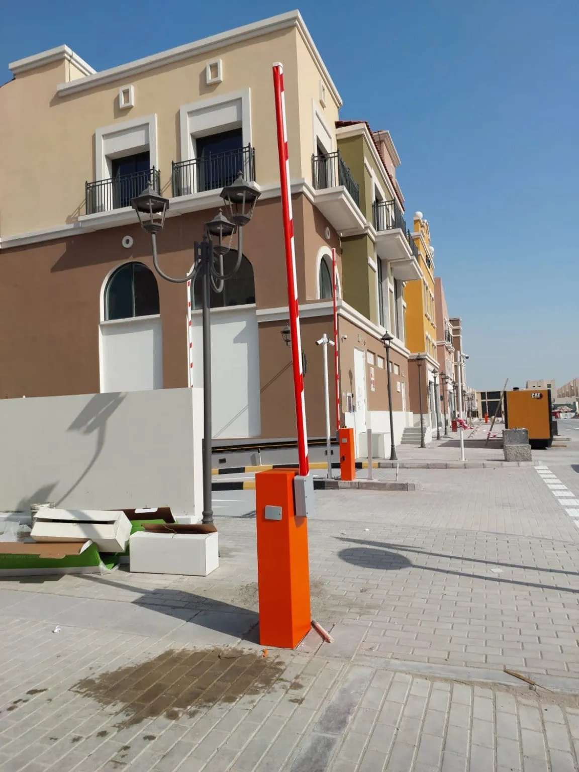 Comunello BORDER 400 Automatic Parking Barrier with an orange metal cabinet and upright red-and-white boom