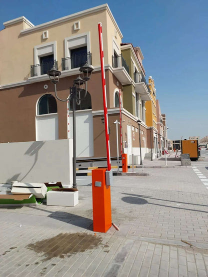 Comunello BORDER 400 Automatic Parking Barrier with an orange metal cabinet and upright red-and-white boom