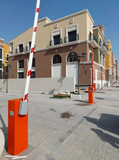 Comunello BORDER 400 Automatic Parking Barrier with an orange cabinet and raised white boom with red stripes