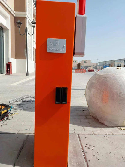 Comunello BORDER 400 Automatic Parking Barrier with an orange metal cabinet, silver logo badge and black recessed panel