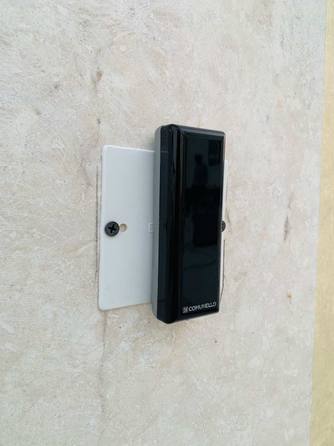Comunello DART SLIM Gate Safety Photocells with a slim black rectangular sensor housing mounted on a white plate.