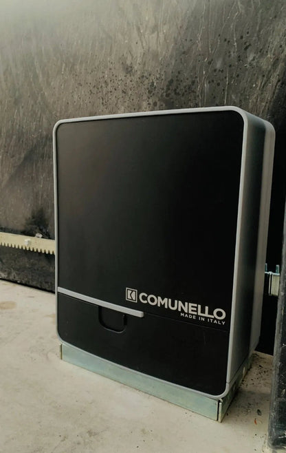 Comunello FORT 1500 Sliding Gate Motor with a black plastic cover, grey trim, front logo and toothed rack