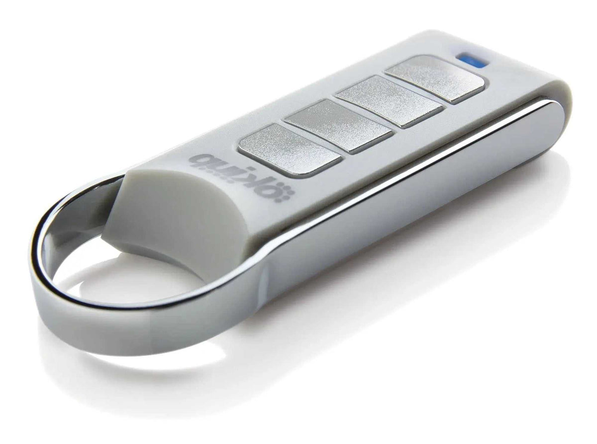Quiko 4-Channel Gate Remote in silver and white with four rectangular buttons, a blue indicator and keyring loop