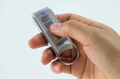 Quiko 4-Channel Gate Remote in silver and grey plastic with four dark buttons, a blue indicator and metal key ring