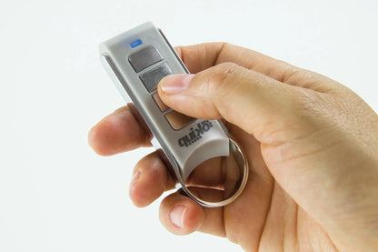 Quiko 4-Channel Gate Remote in silver and grey plastic with rectangular buttons, a blue indicator and metal keyring