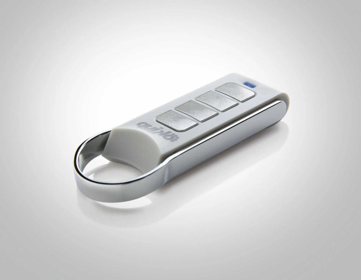 Quiko 4-Channel Gate Remote in white and silver with four rectangular buttons and a metal loop at one end