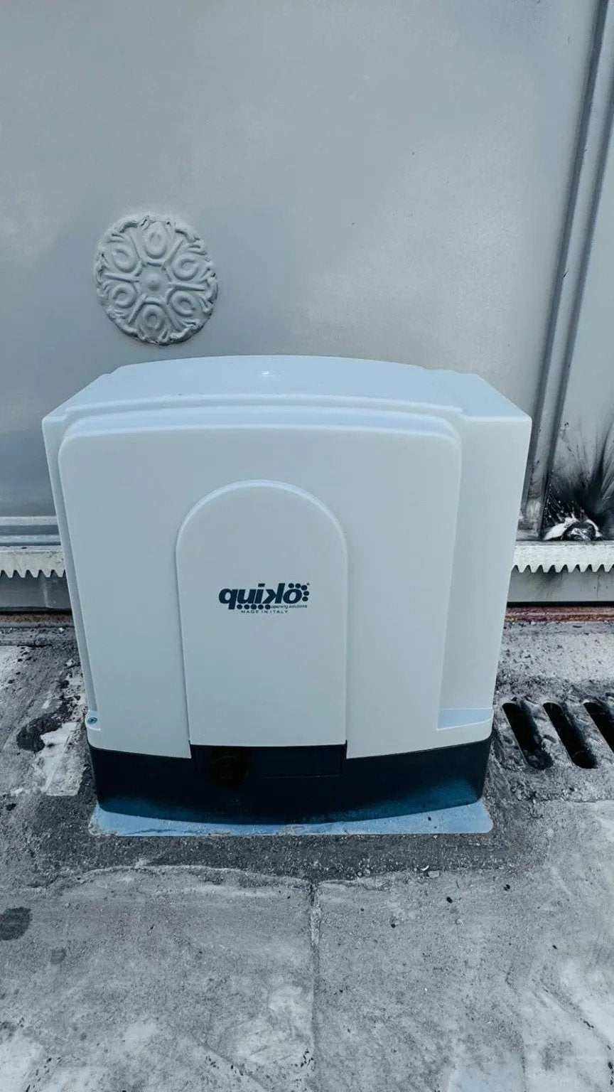 Quiko MOOVY sliding gate operator in Qatar, white plastic housing with a dark base and Quiko logo