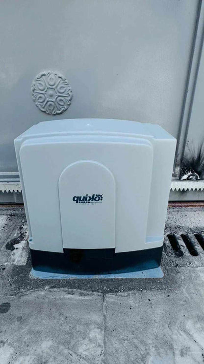 Quiko MOOVY sliding gate operator in Qatar, white plastic housing with a dark base and Quiko logo