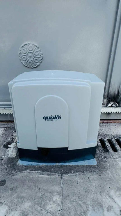 Quiko MOOVY Sliding Gate Operator with a light gray plastic housing, rounded rectangular shape and Quiko logo.